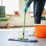 Mopping a hard floor during an office clean in East Legon, Accra