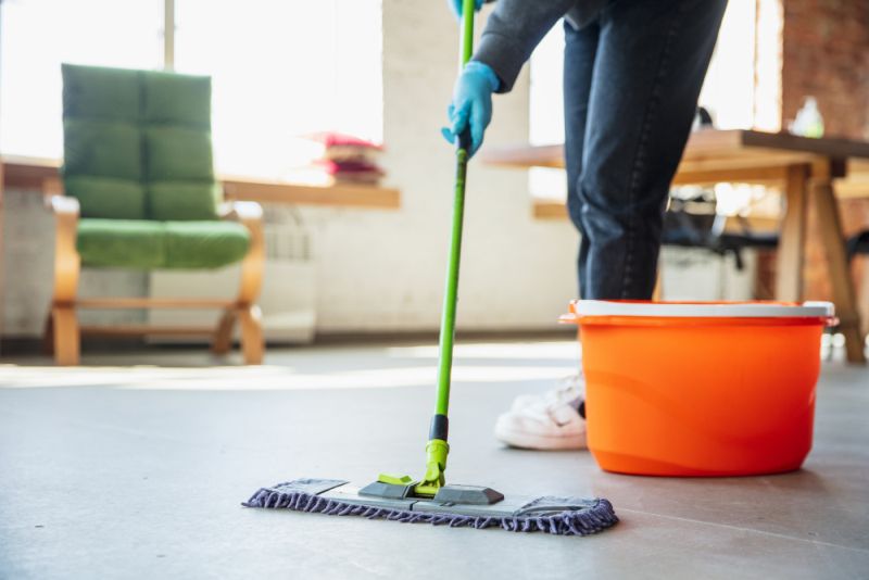 Mopping a hard floor during an office clean in East Legon, Accra