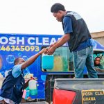 Posh Clean crew handling treatment chemicals at the company truck for a fumigation job in Ghana