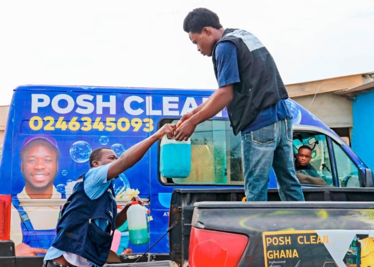 Posh Clean crew handling treatment chemicals at the company truck for a fumigation job in Ghana