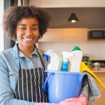 Posh Clean housekeeper with cleaning supplies in a home kitchen in Accra
