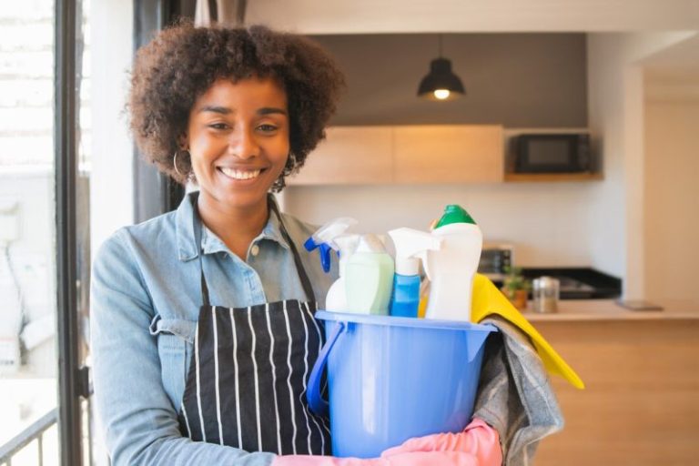 Posh Clean housekeeper with cleaning supplies in a home kitchen in Accra