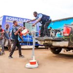 Posh Clean Services crew unloading equipment from the branded truck on a job site in Ghana